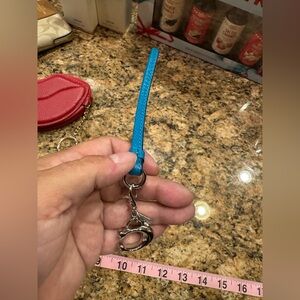 Coach teal leather wristlet keychain with a silver-tone Coach logo charm